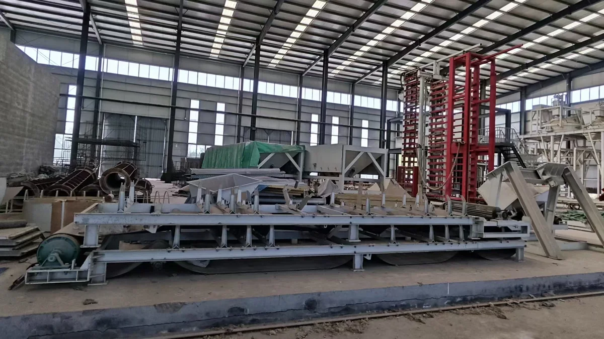 Wide view of block production equipment and handling structures in a workshop